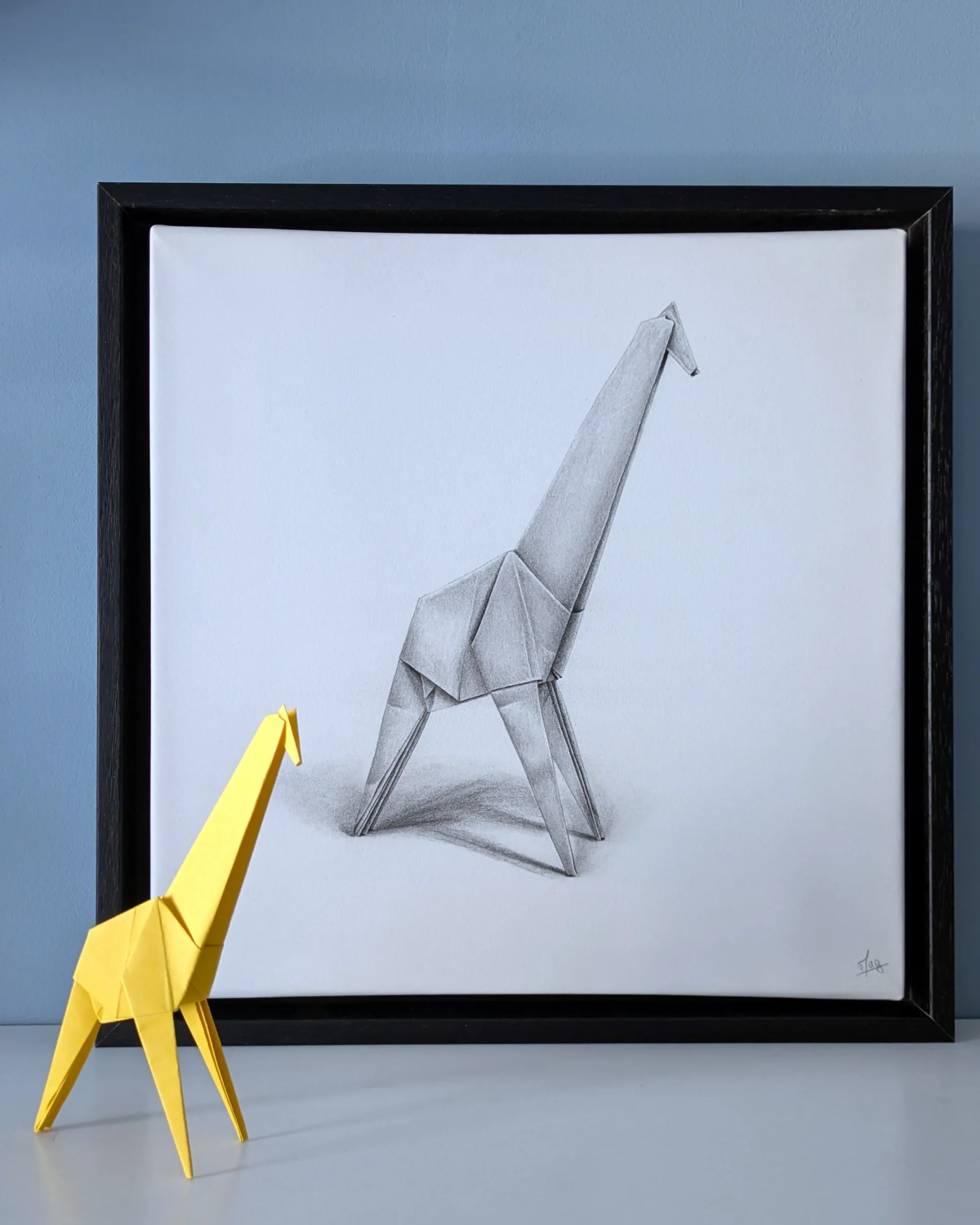 A hyperrealistic drawing with a 3D effect depicting an origami giraffe, created by artist Magali Lapeyre-Mirande, on watercolor paper stretched over a frame and mounted in a shadow box