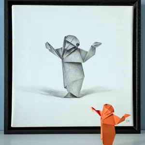 A hyperrealistic drawing with a 3D effect depicting an origami monkey, created by artist Magali Lapeyre-Mirande, on watercolor paper stretched over a frame and mounted in a shadow box